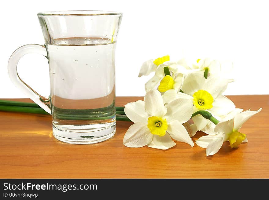 Bouquet of narcissuses and cup of water. Bouquet of narcissuses and cup of water