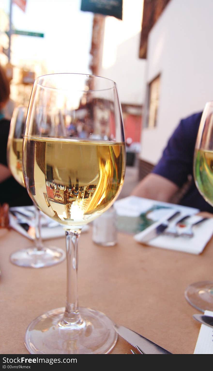 Friends having wine at a street side restaurant. Friends having wine at a street side restaurant