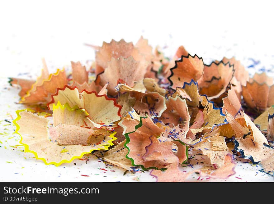 Colourful pencils sawdust over white