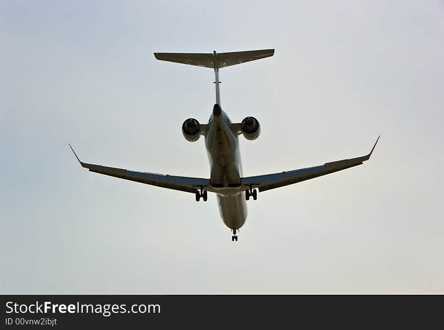 Silhouette of an aeroplane while landing at the urban airport. Silhouette of an aeroplane while landing at the urban airport