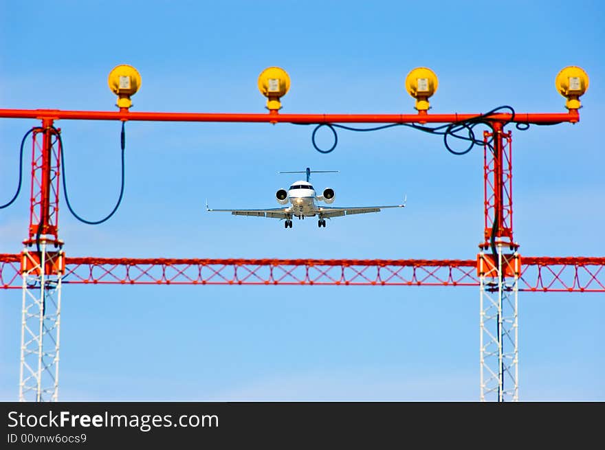 Aeroplane landing or flying away with a blue sky in the background. Aeroplane landing or flying away with a blue sky in the background