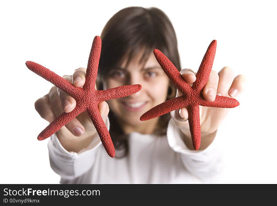 Young woman playing with red starfish seashell