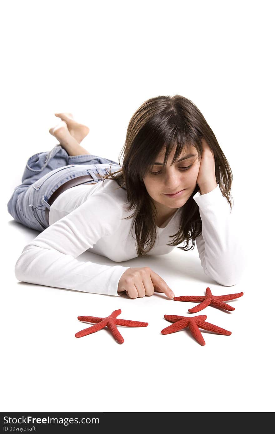 Young woman playing with red starfish seashell isolated on white background