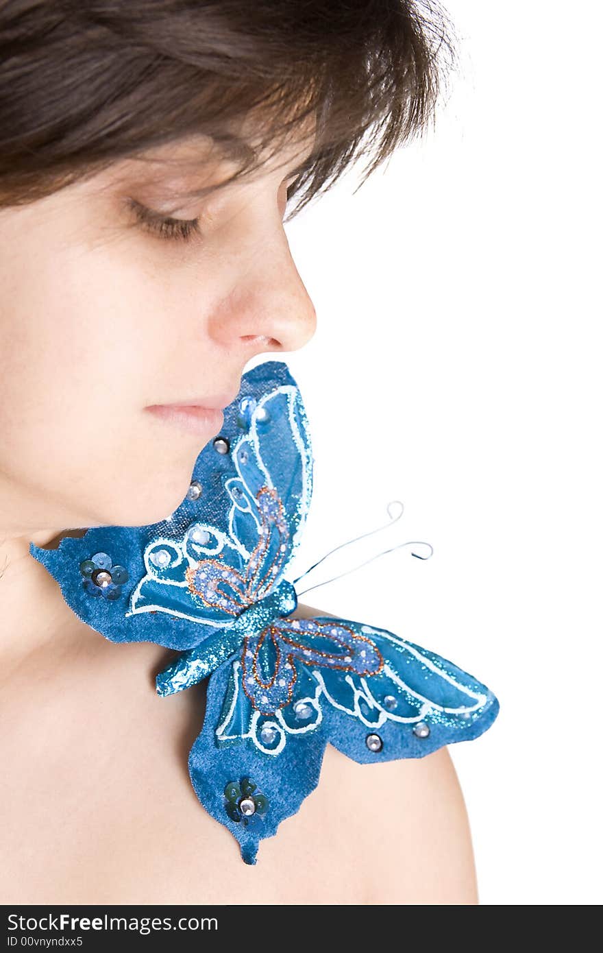 Beautiful young woman with blue butterfly in her naked shoulder - focus on the eye