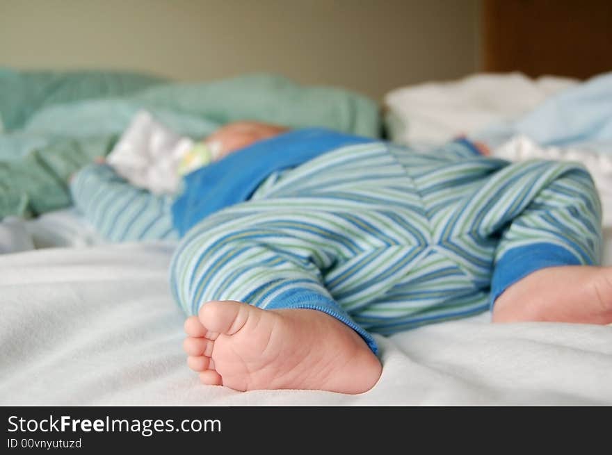 Feet of a little baby sound asleep at naptime. Feet of a little baby sound asleep at naptime