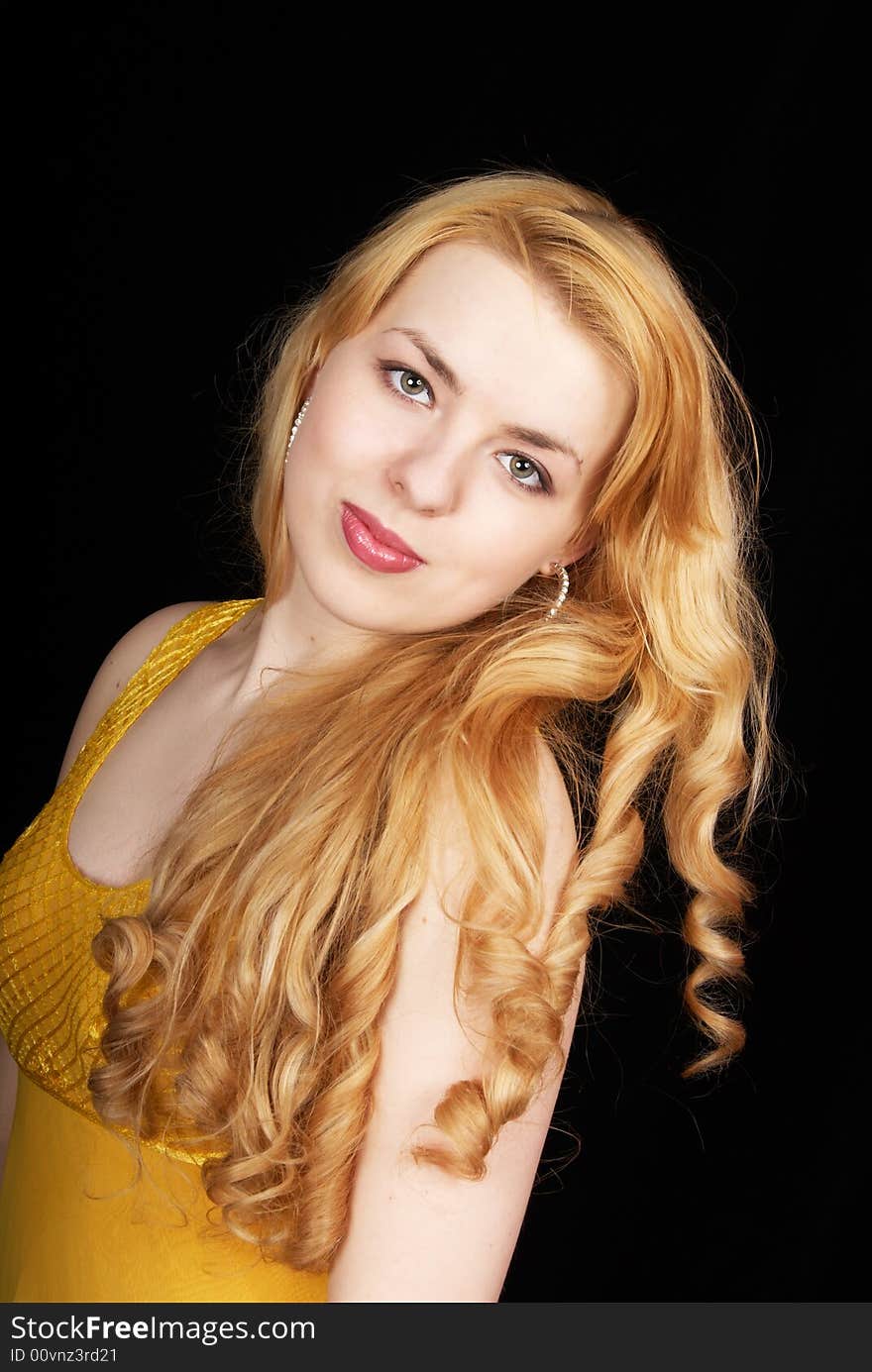 Pretty young girl in yellow dress on black background