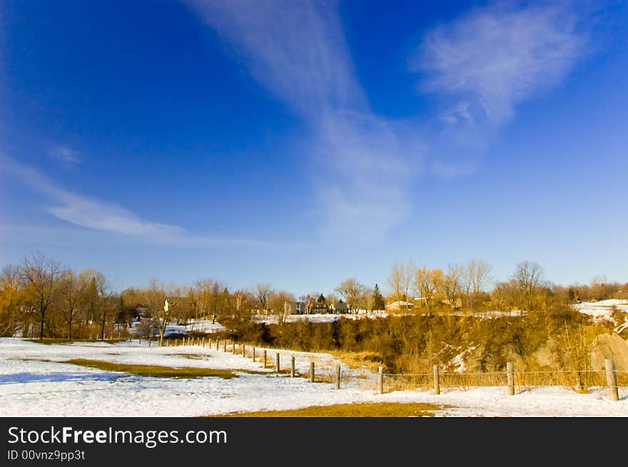 A landscape with some snow on the ground, blue sky in begining of spring. A landscape with some snow on the ground, blue sky in begining of spring