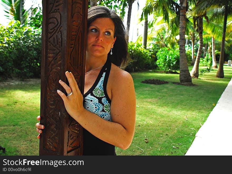 Beautiful woman in colorful dress in tropical setting. Beautiful woman in colorful dress in tropical setting.