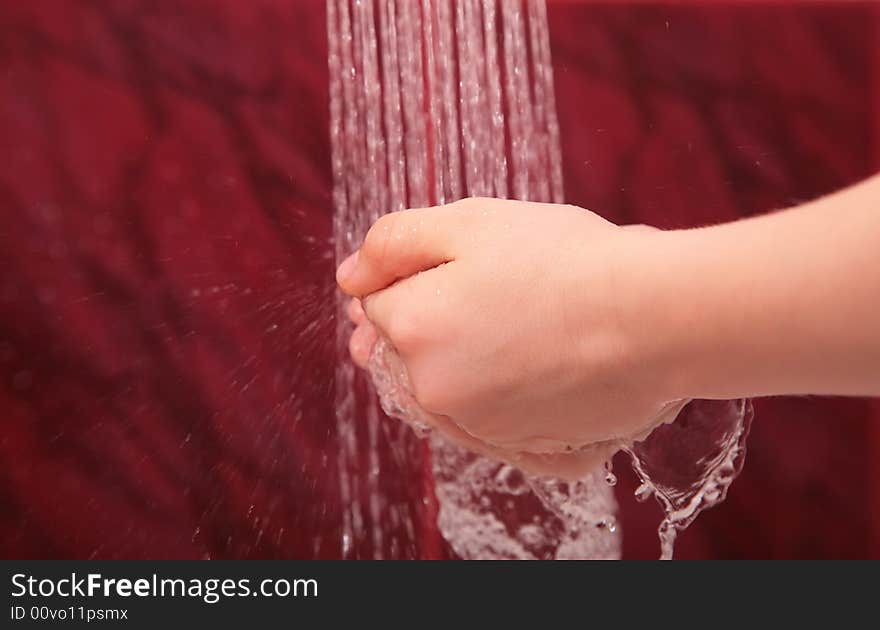 Hands under water jets from shower