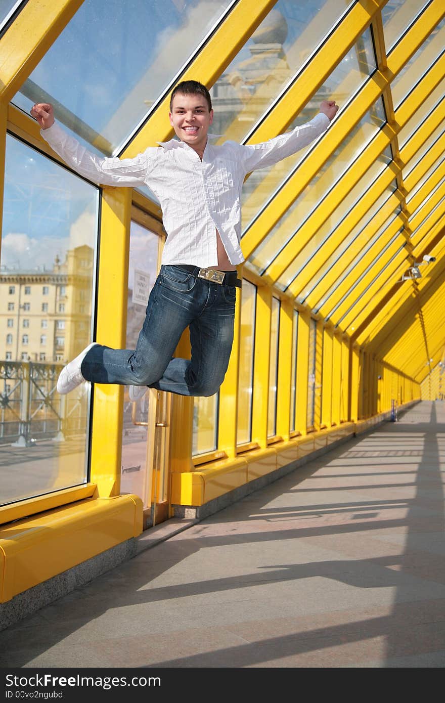 Young man jumps on footbridge