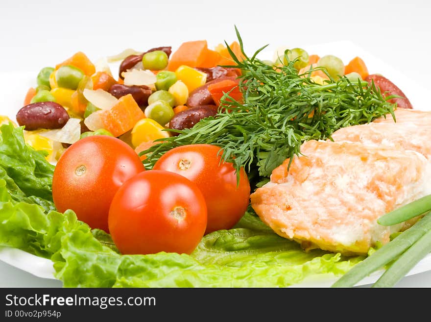 Stake from a salmon with vegetables on a plate