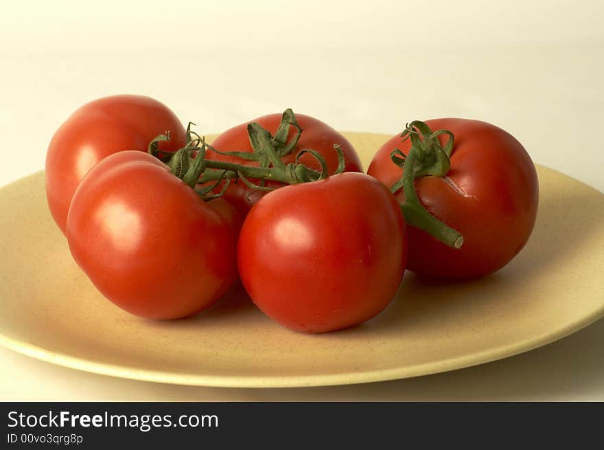 Five tomatoes into a dish. Five tomatoes into a dish