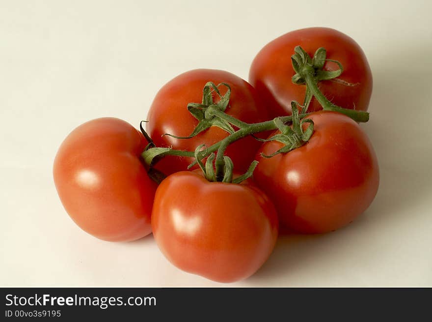 Five tomatoes into a white background. Five tomatoes into a white background