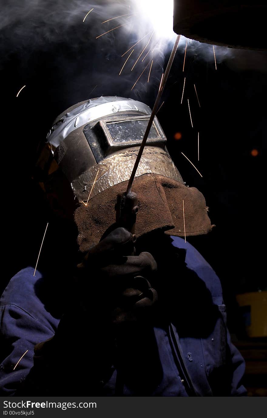 A welder working at shipyard at night. A welder working at shipyard at night