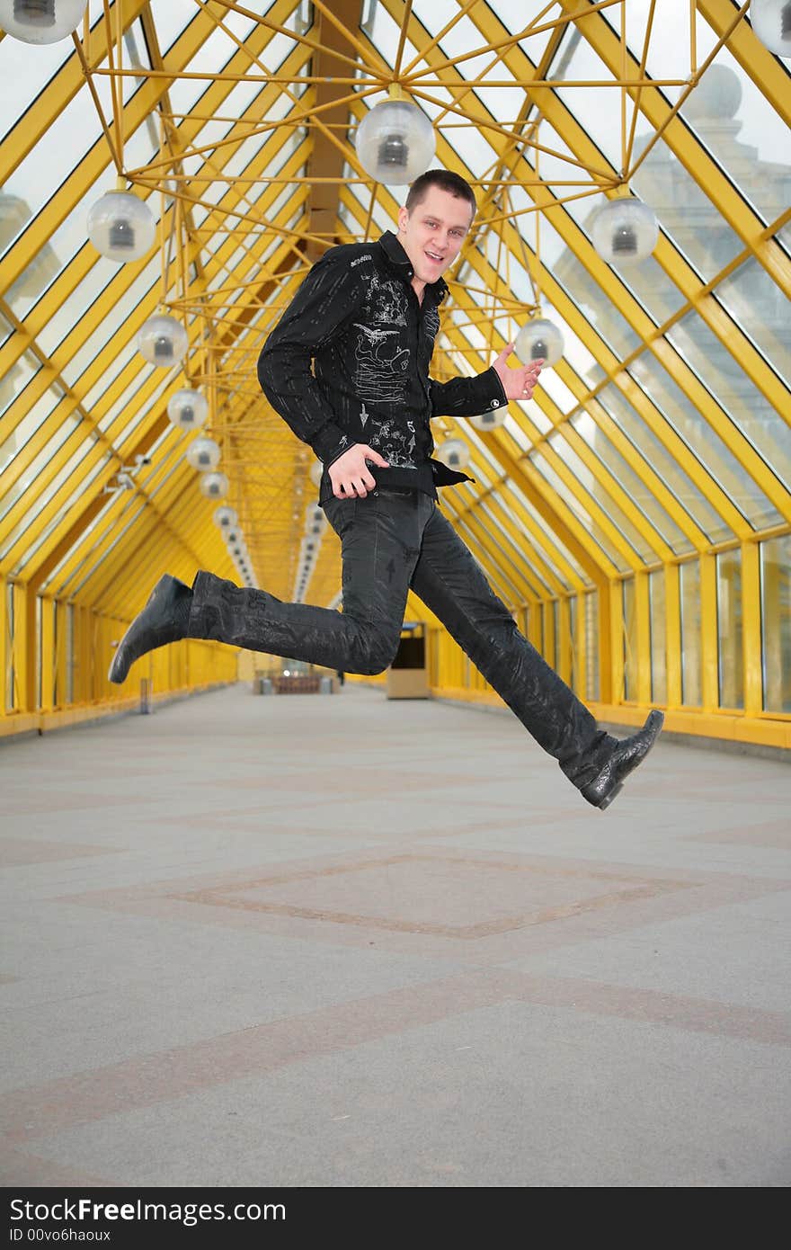 Guy jump and allegorize play on guitar on footbridge. Guy jump and allegorize play on guitar on footbridge