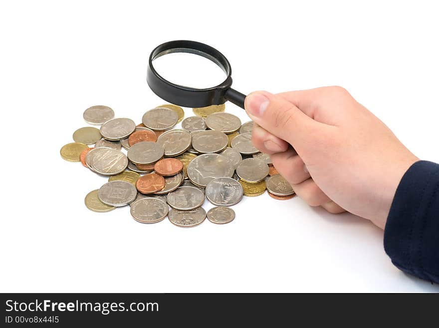 Coins and magnifier in hand on white