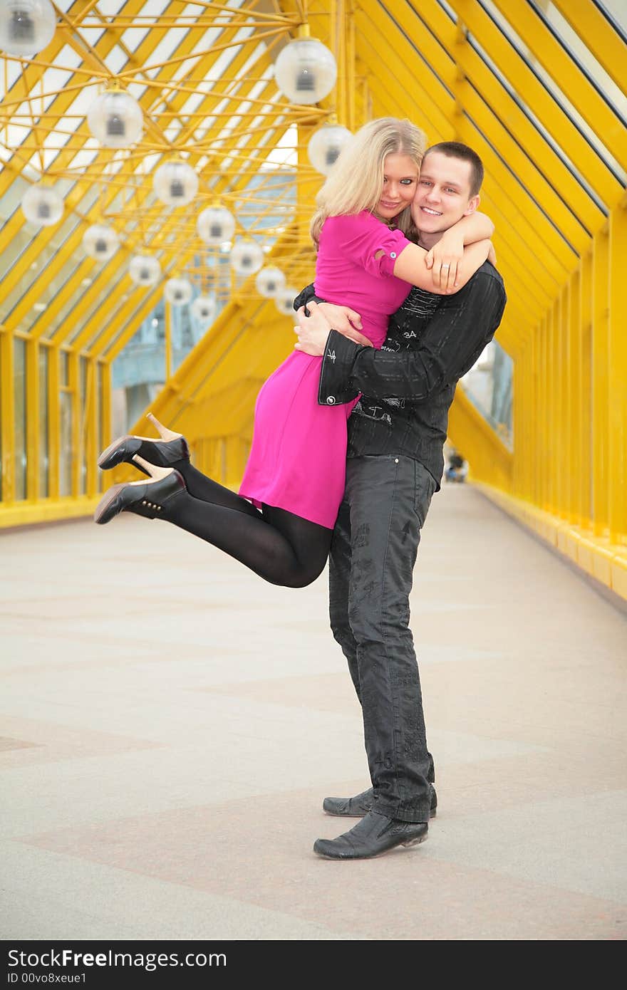 Boy hold girl on hand on footbridge