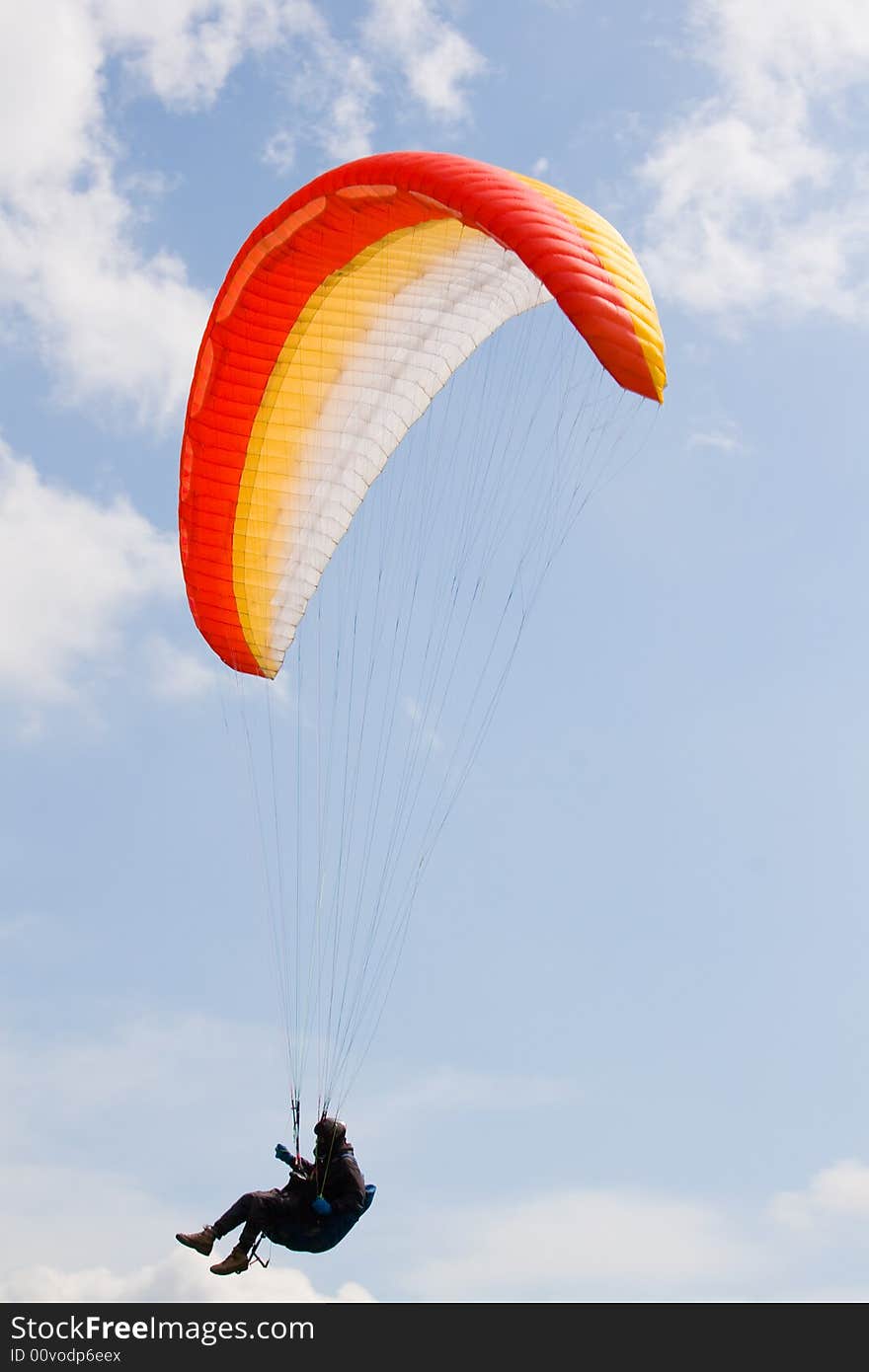 Paraglider in the blue cloudy skies. Paraglider in the blue cloudy skies