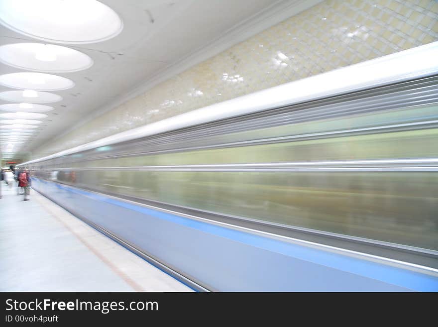 Passengers and moving train on metro station