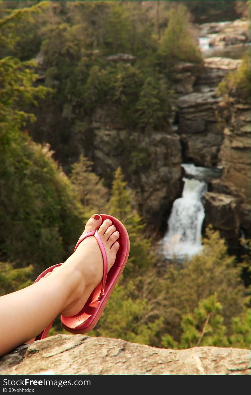 Woman s foot and leg before waterfall