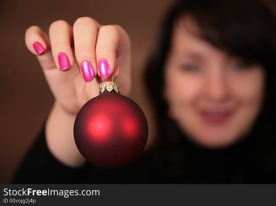 Woman with christmas ball in hand