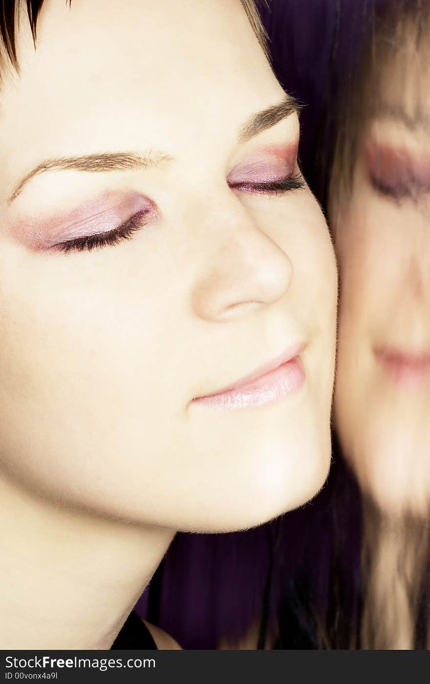 Beautiful woman portrait with face reflection, purple make up, close up