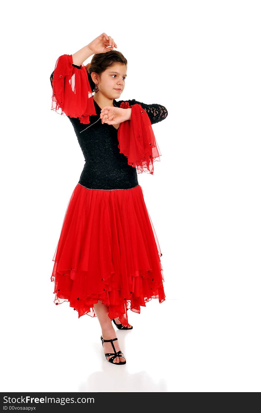 Attractive tween girl dancing the Pasodoble.  Isolated on white.