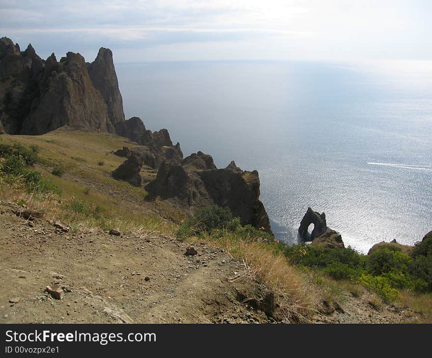 Landscape with sea and rocks on the shore - famouse place called Golden gates (or Devil gates) in Crimea, Black sea. Landscape with sea and rocks on the shore - famouse place called Golden gates (or Devil gates) in Crimea, Black sea.