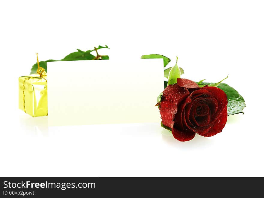 Red rose with a gift and blank card