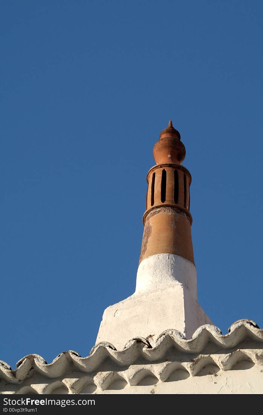 Local chimney from Algarve Portugal in a blue sky