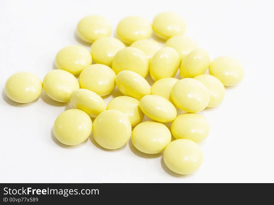 Yellow tablets close-up on the white background