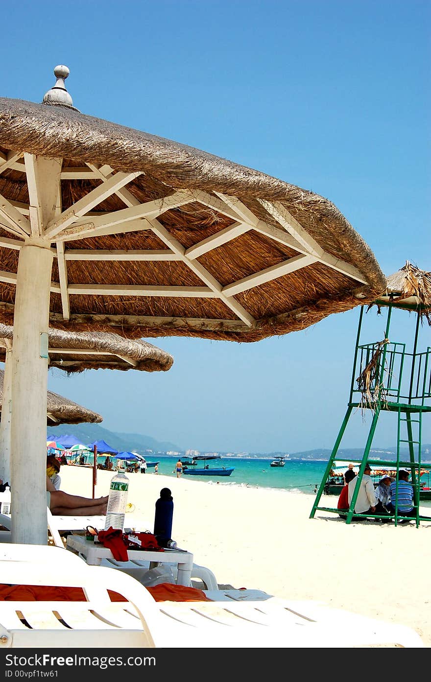 Sun chairs on the beach with sea in background