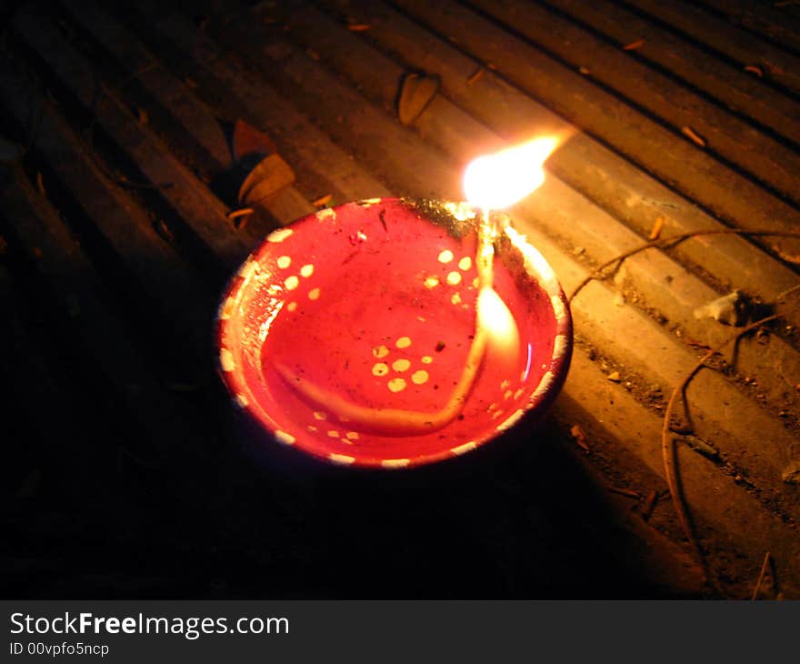 A red colored burning oil lamp kept in the dark