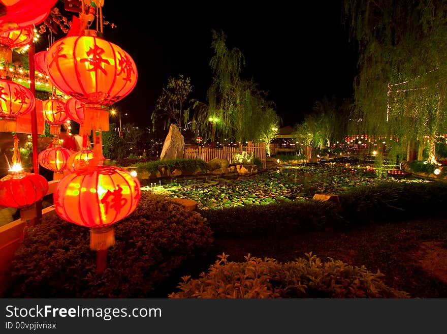 Red lanterns raised at prayer ceremony in temple grounds, taken at night. Red lanterns raised at prayer ceremony in temple grounds, taken at night