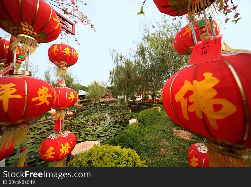 Red lanterns raised at prayer ceremony in temple grounds. Red lanterns raised at prayer ceremony in temple grounds