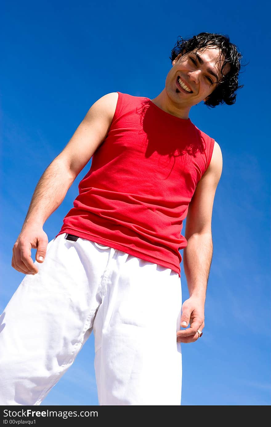 Cheerful young athlete on the beach