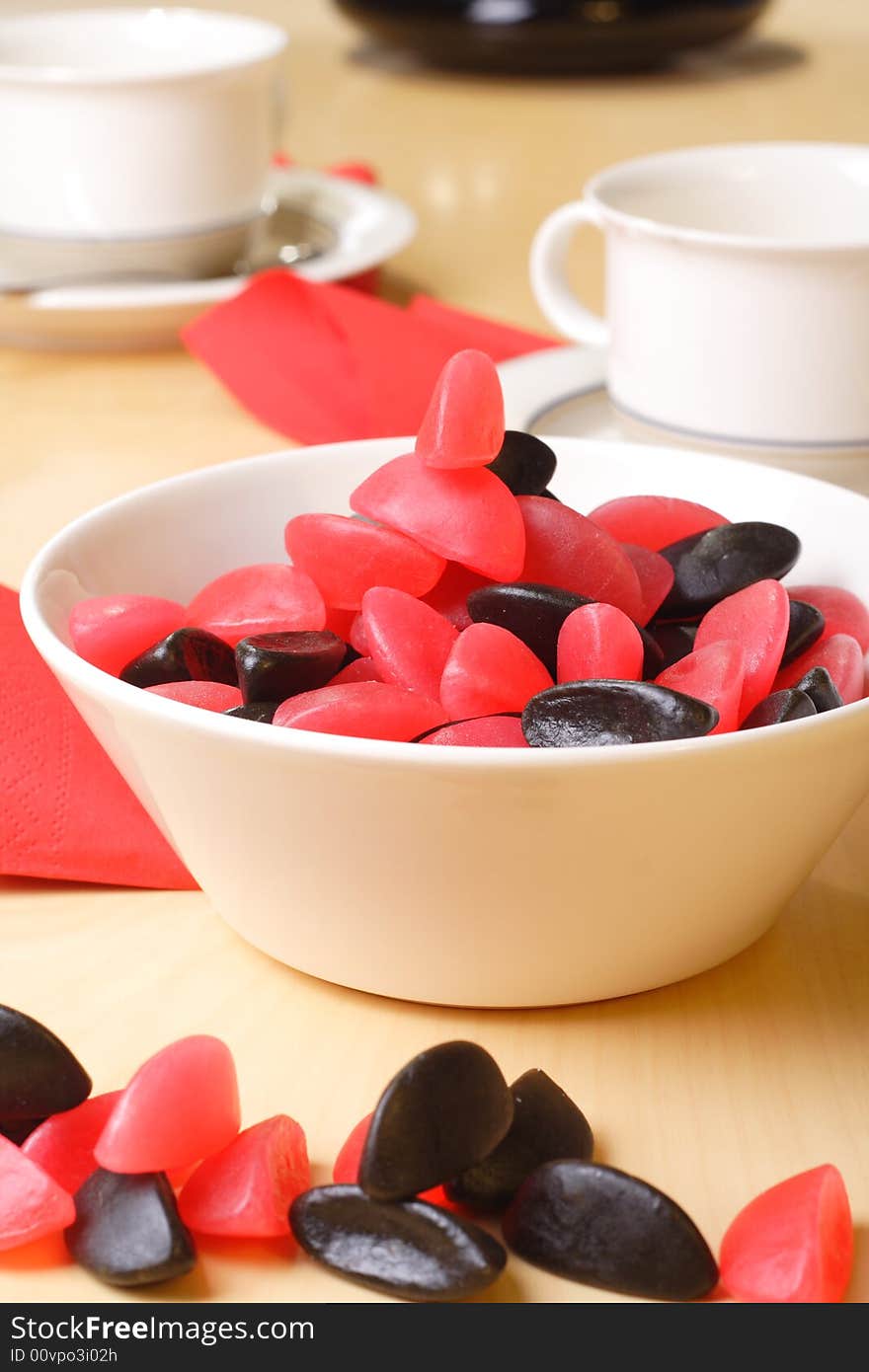 Candy with coffee cups in the background. Candy with coffee cups in the background