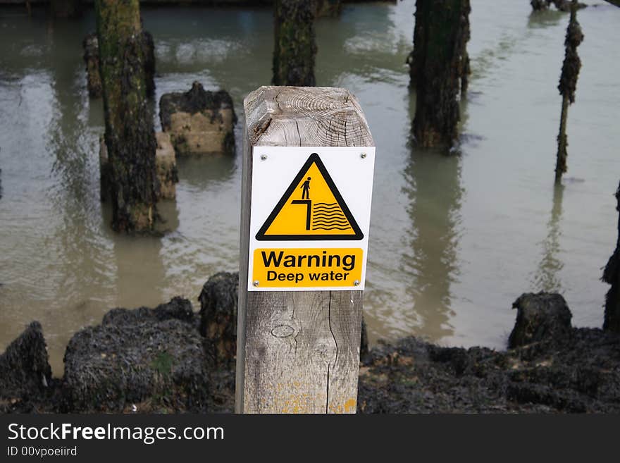 A deep water sign at the edge of the sea