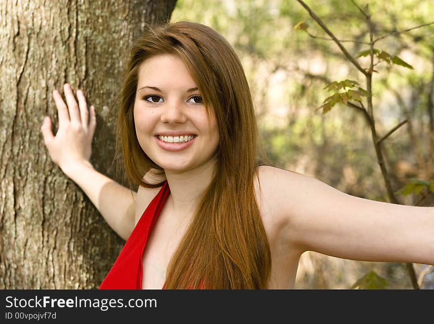 Beautiful woman in red dress, standing in forest. Beautiful woman in red dress, standing in forest