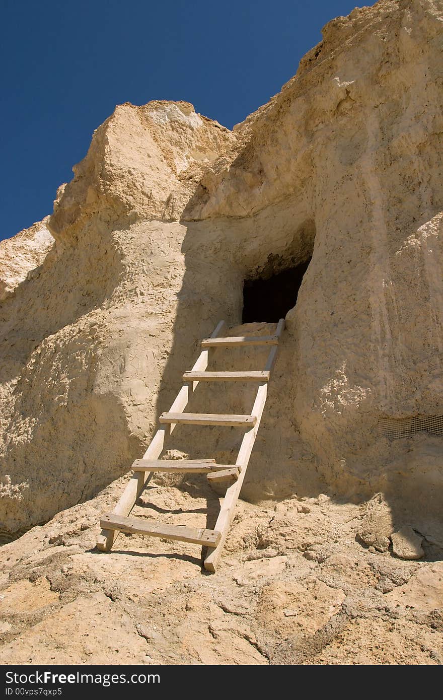 Wooden ladder ascending to cliff dwelling, Kazakhstan. Wooden ladder ascending to cliff dwelling, Kazakhstan