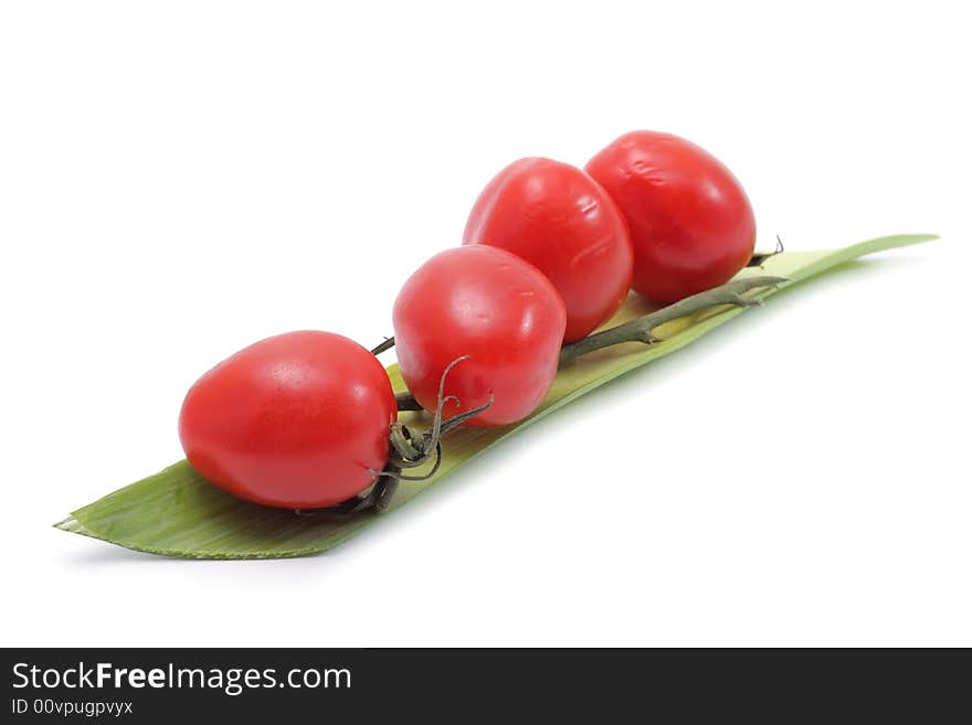 Vegetable still life of cherry tomato and salad. Isolated on a white background. Vegetable still life of cherry tomato and salad. Isolated on a white background