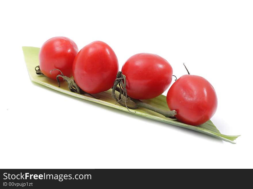 Vegetable still life of cherry tomato and salad. Isolated on a white background