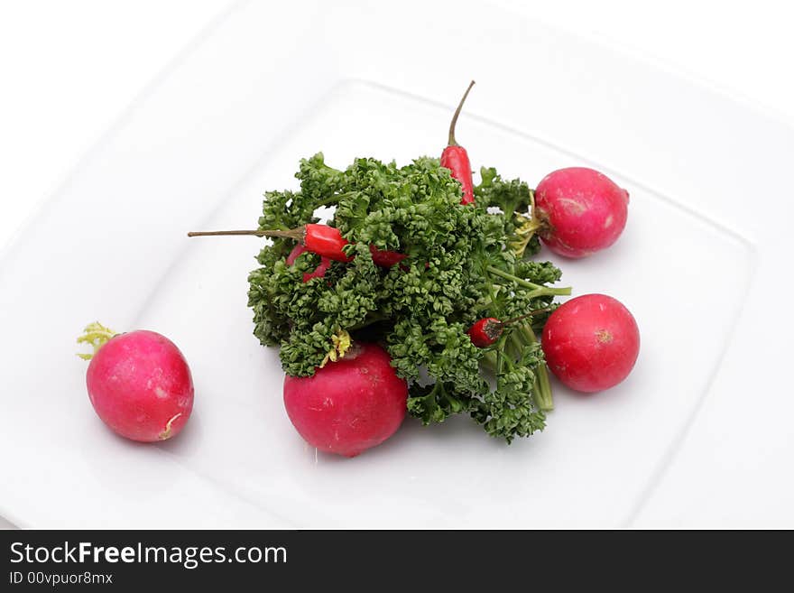 Vegetables on a plate. Isolated on a white background. Vegetables on a plate. Isolated on a white background