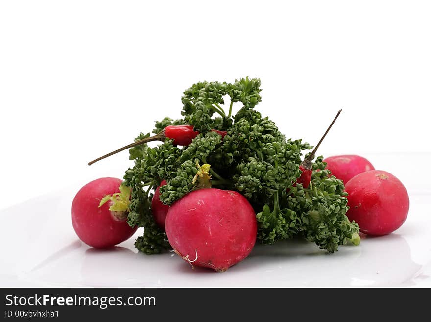 Vegetables on a plate. Isolated on a white background. Vegetables on a plate. Isolated on a white background