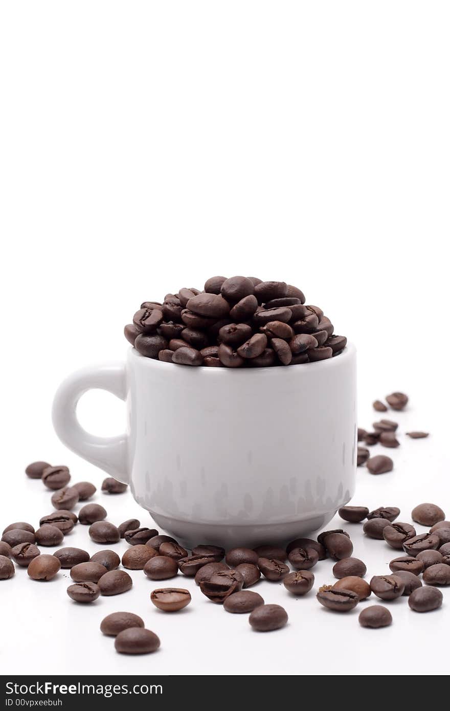 Cofee seed in a cup isolated on a white background