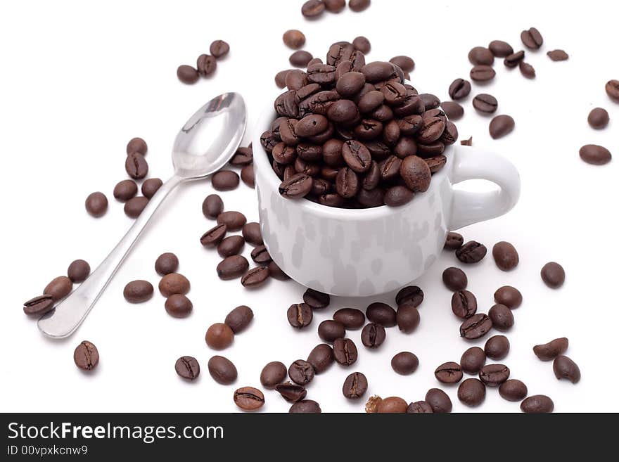 Cofee seed in a cup isolated on a white background