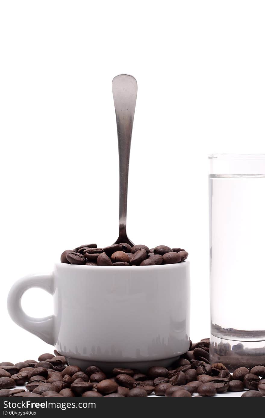 Cofee seed in a cup isolated on a white background