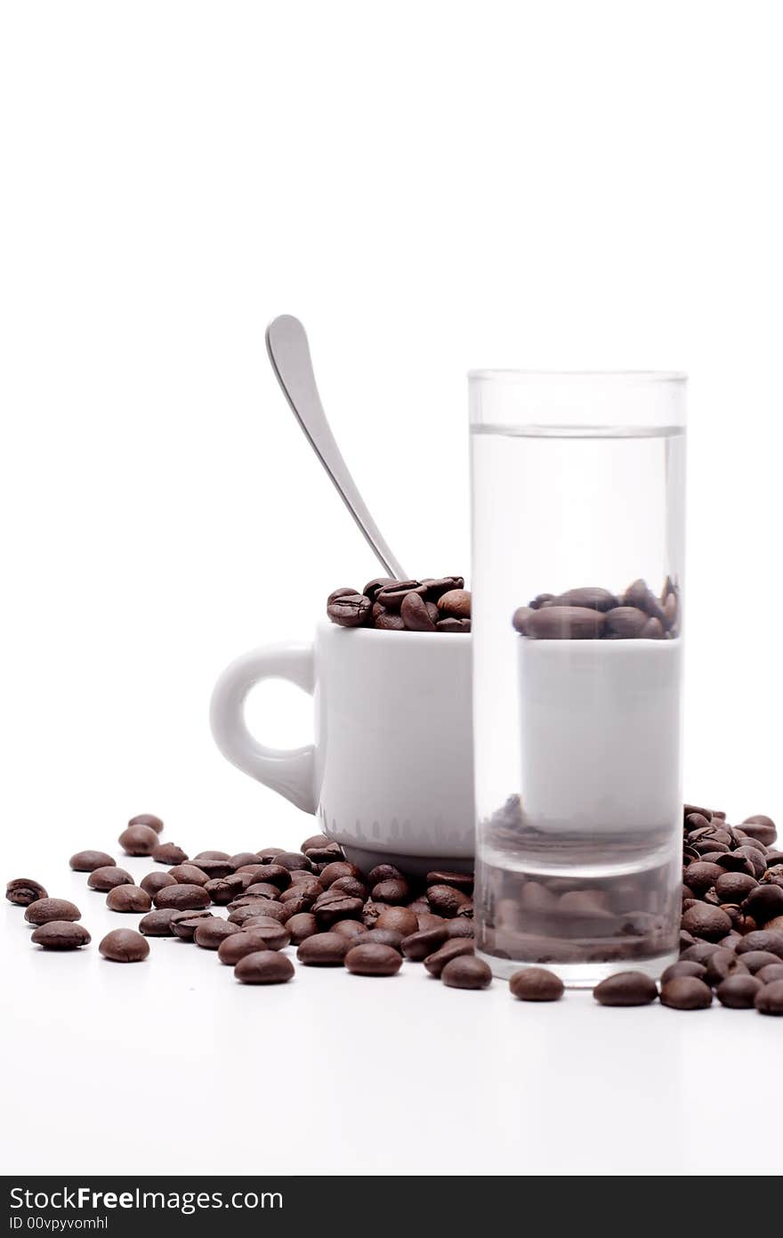 Cofee seed in a cup isolated on a white background