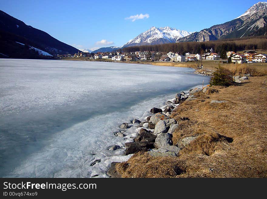 Alpine village on frozen lake