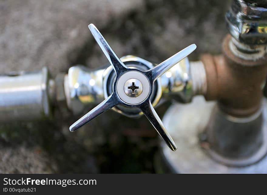 Shiny steel tap with on public drinking fountain. Shiny steel tap with on public drinking fountain.